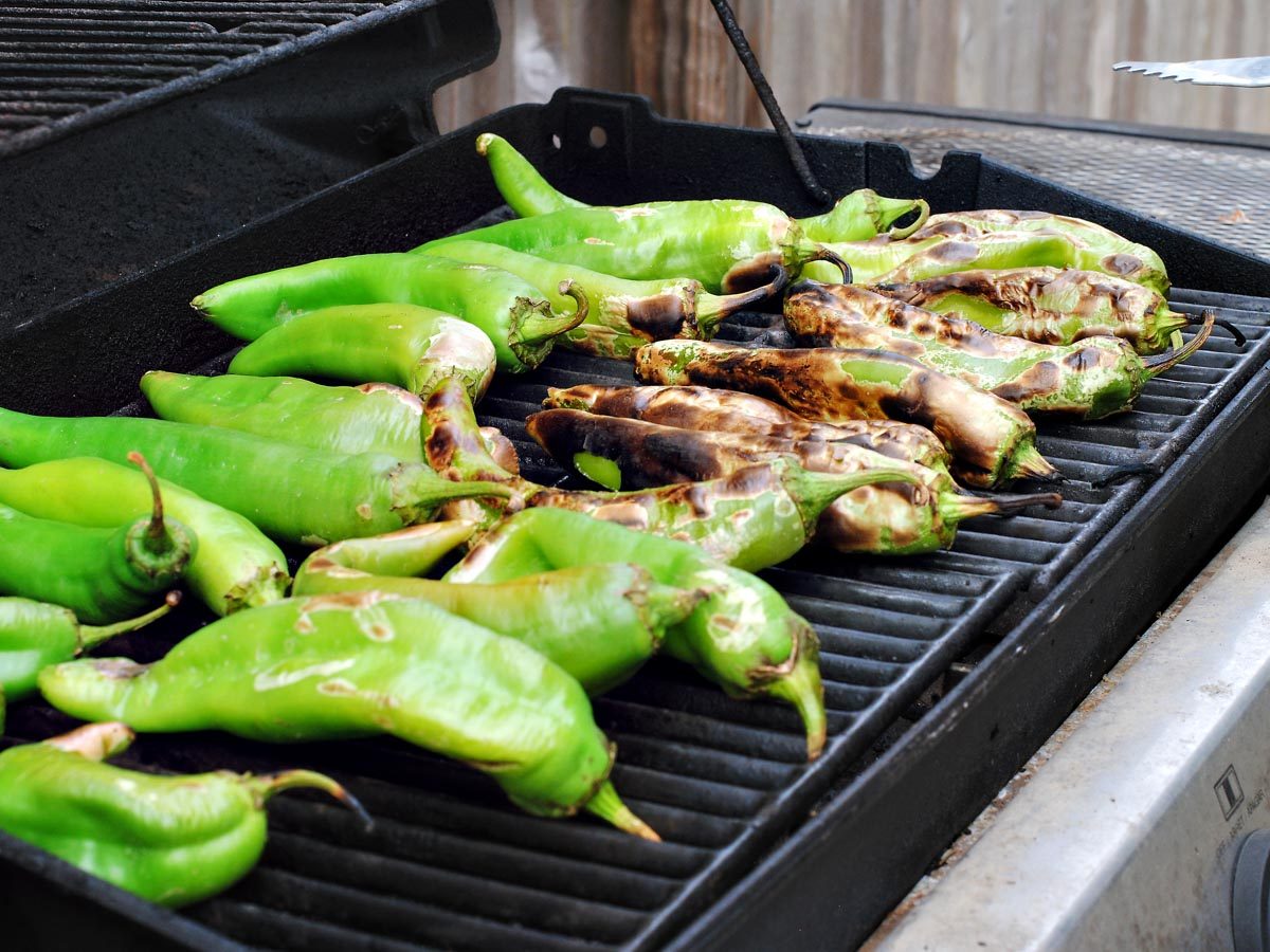 green chiles roasting on a grill