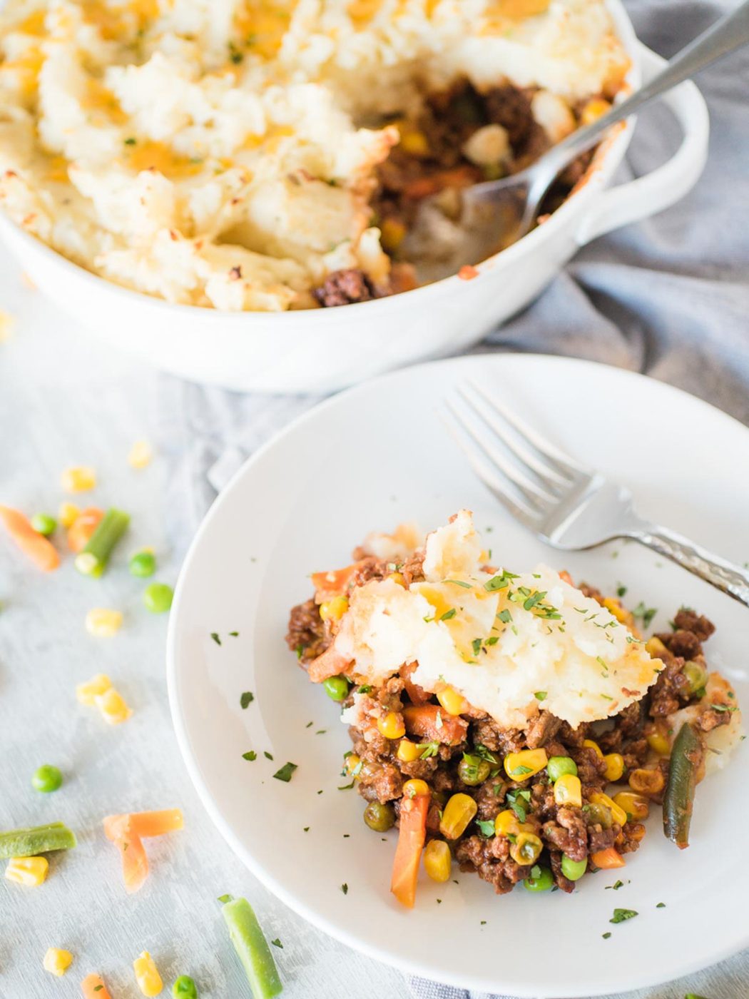 a serving of shepherds pie in a white shallow bowl