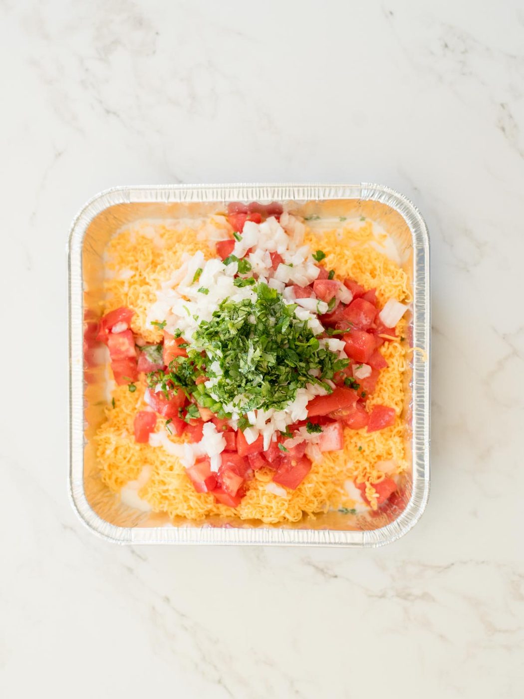 all ingredients for smoked queso dip in an aluminum pan
