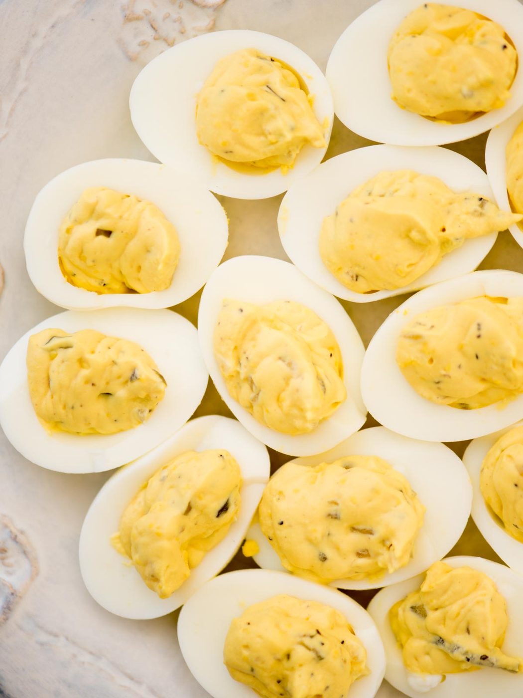 Top view of Southern Deviled Eggs served on a decorative white platter.