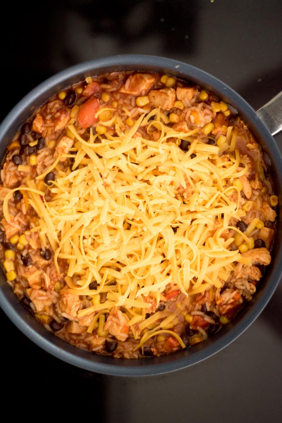Cheese added to the skillet for southwest chicken and rice skillet.