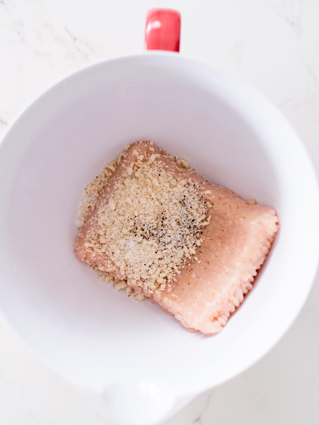 ground chicken, salt, pepper, and panko breadcrumbs in a mixing bowl