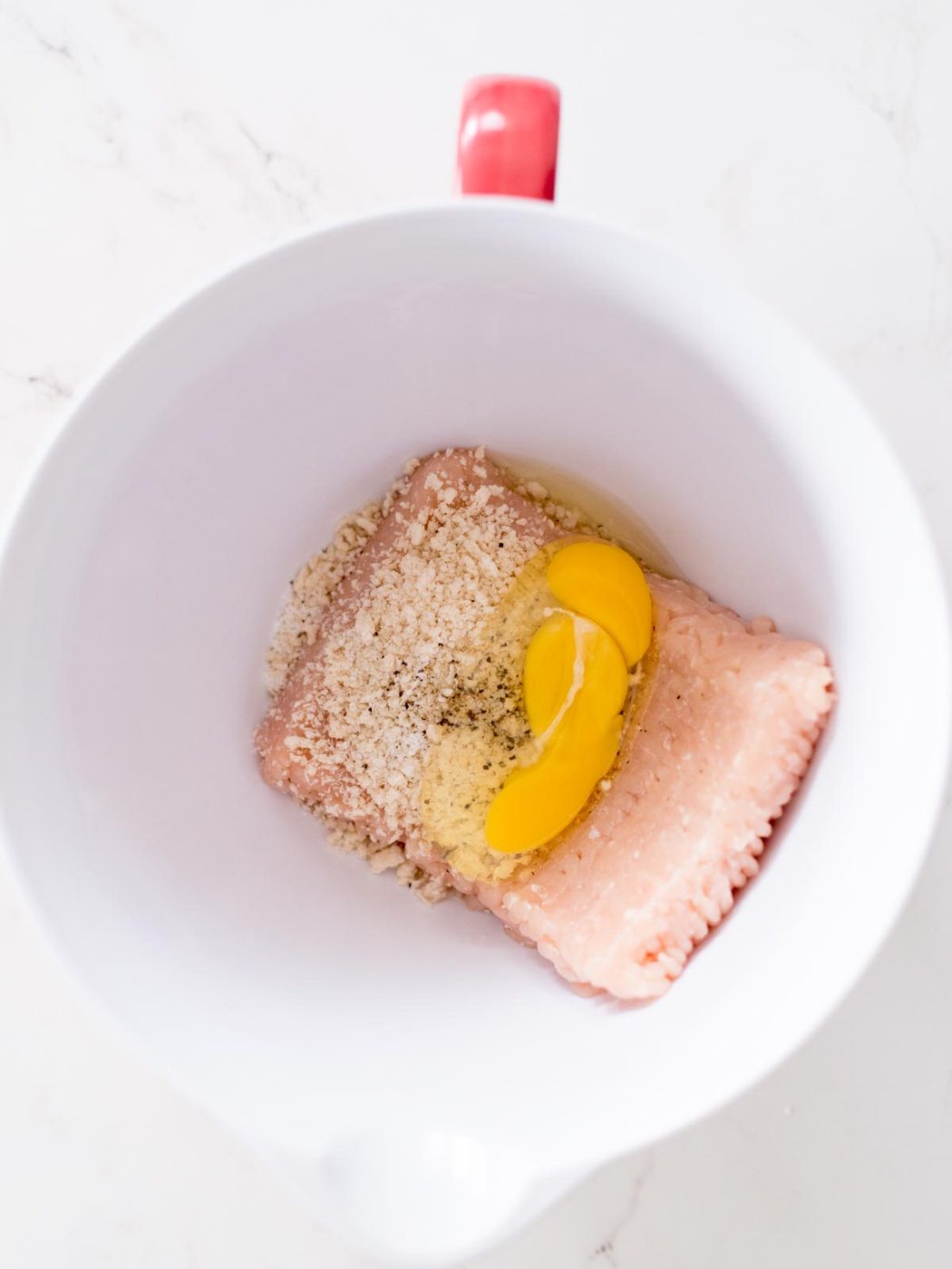 ground chicken, panko breadcrumbs, salt, pepper, and egg in a mixing bowl