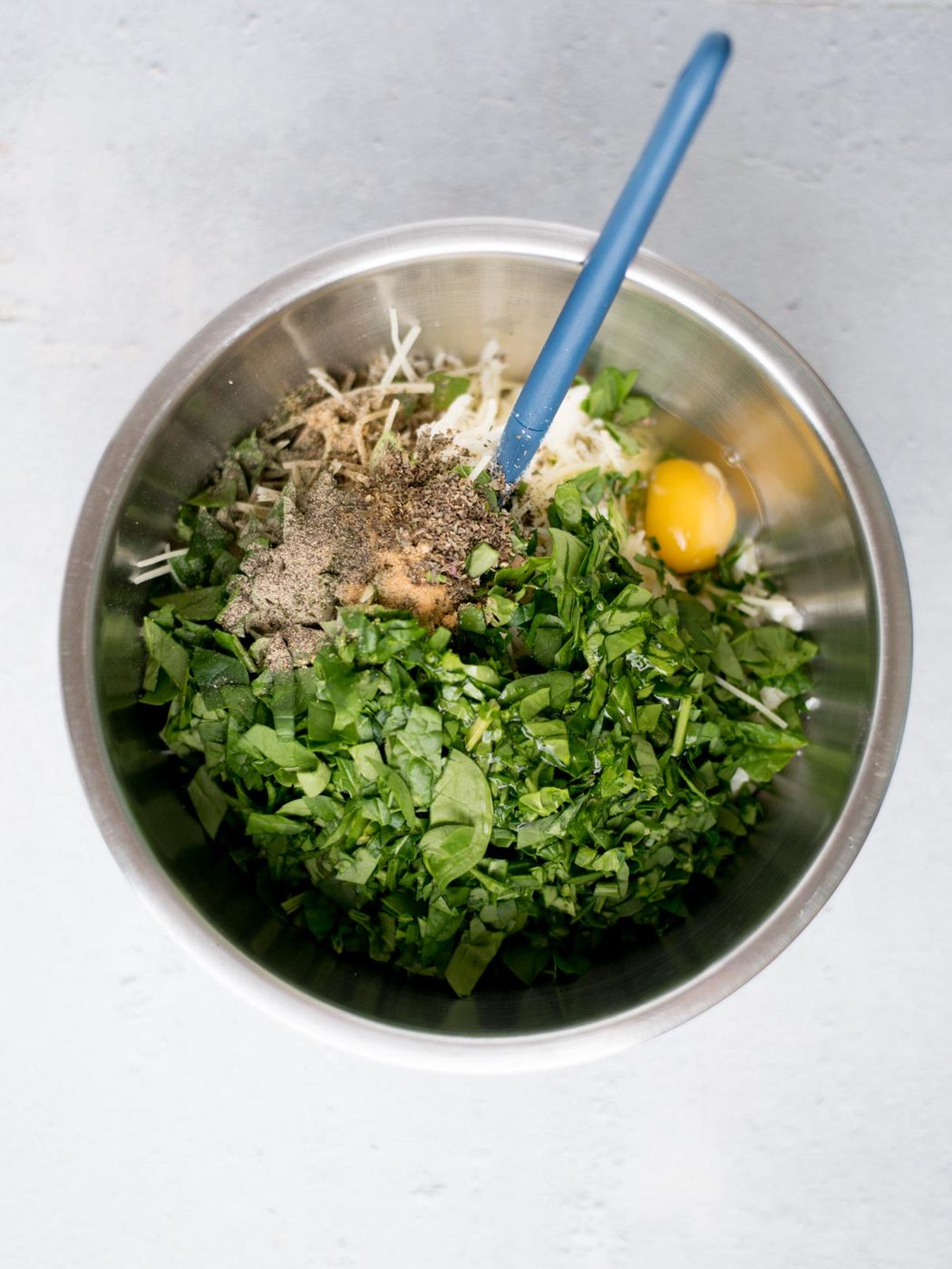 ingredients for the ricotta filling of stuffed shells in a mixing bowl