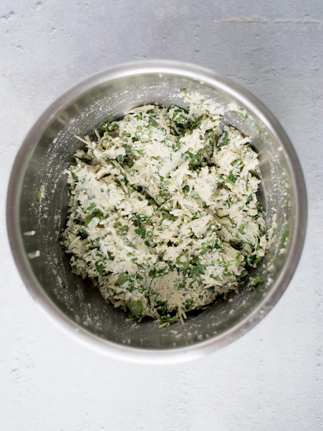 mixed ricotta filling for stuffed shells in a mixing bowl