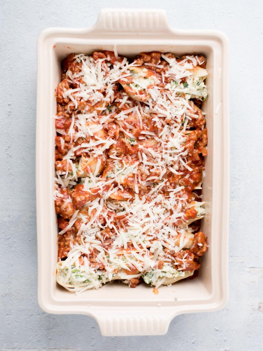 unbaked stuffed shells in a baking dish