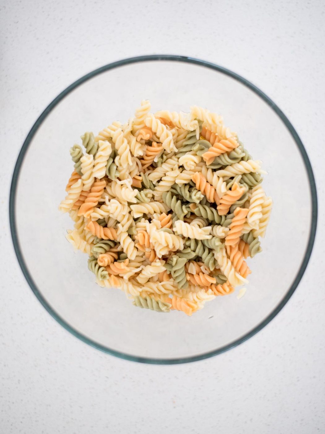 cooked rotini pasta in a mixing bowl