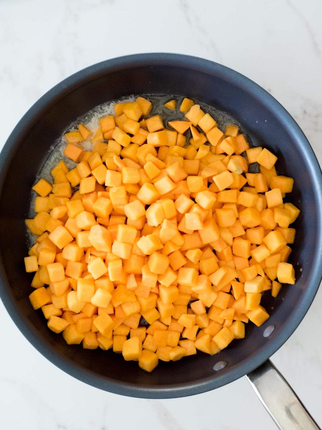 butternut squash in a skillet with butter