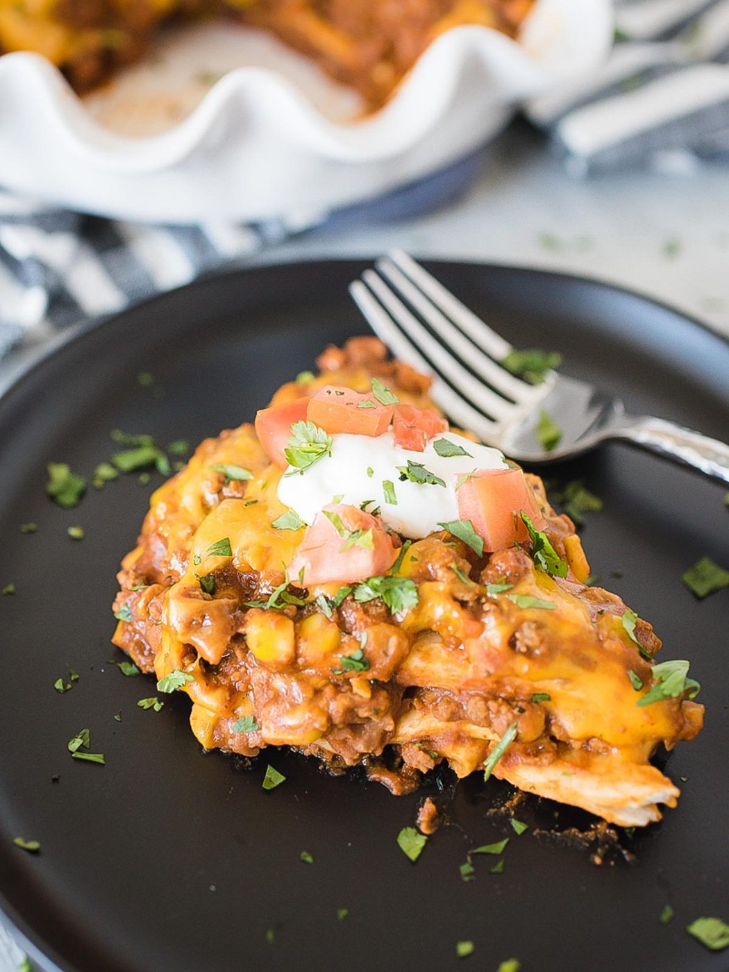 a slice of taco pie on a black plate