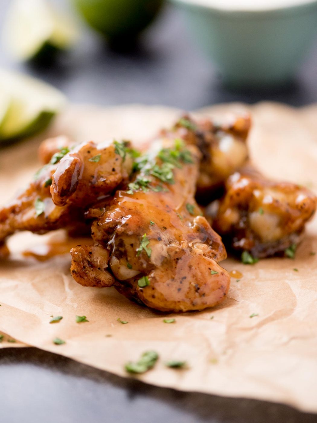 Tequila lime chicken wings laying on parchment paper.