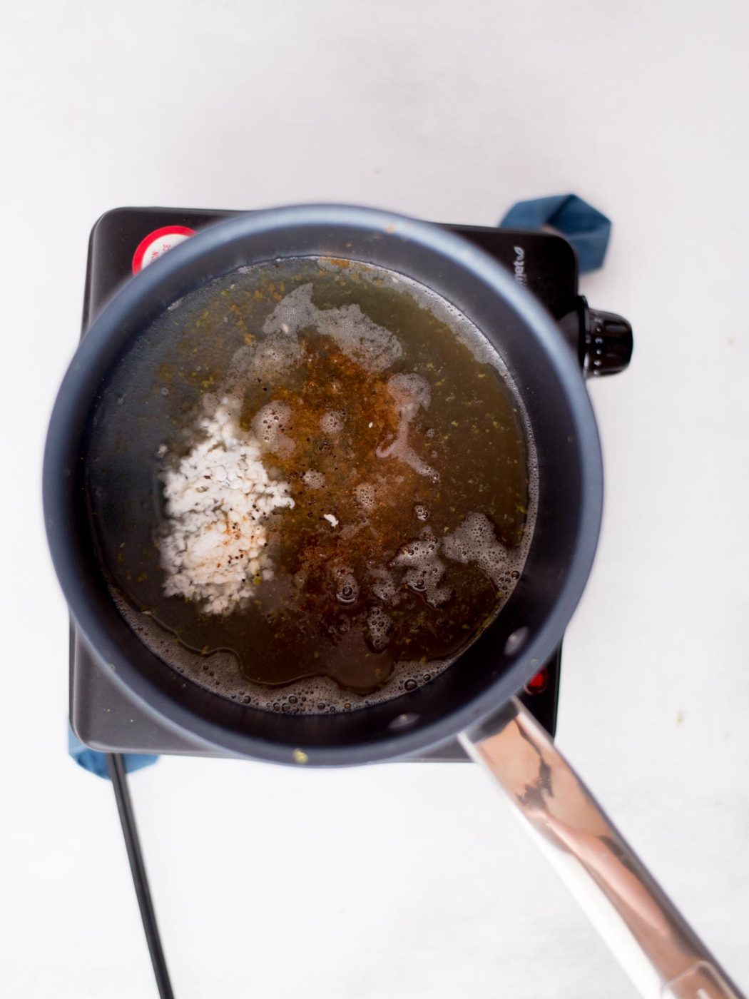 Tequila lime sauce ingredients measured and added to a saucepan.