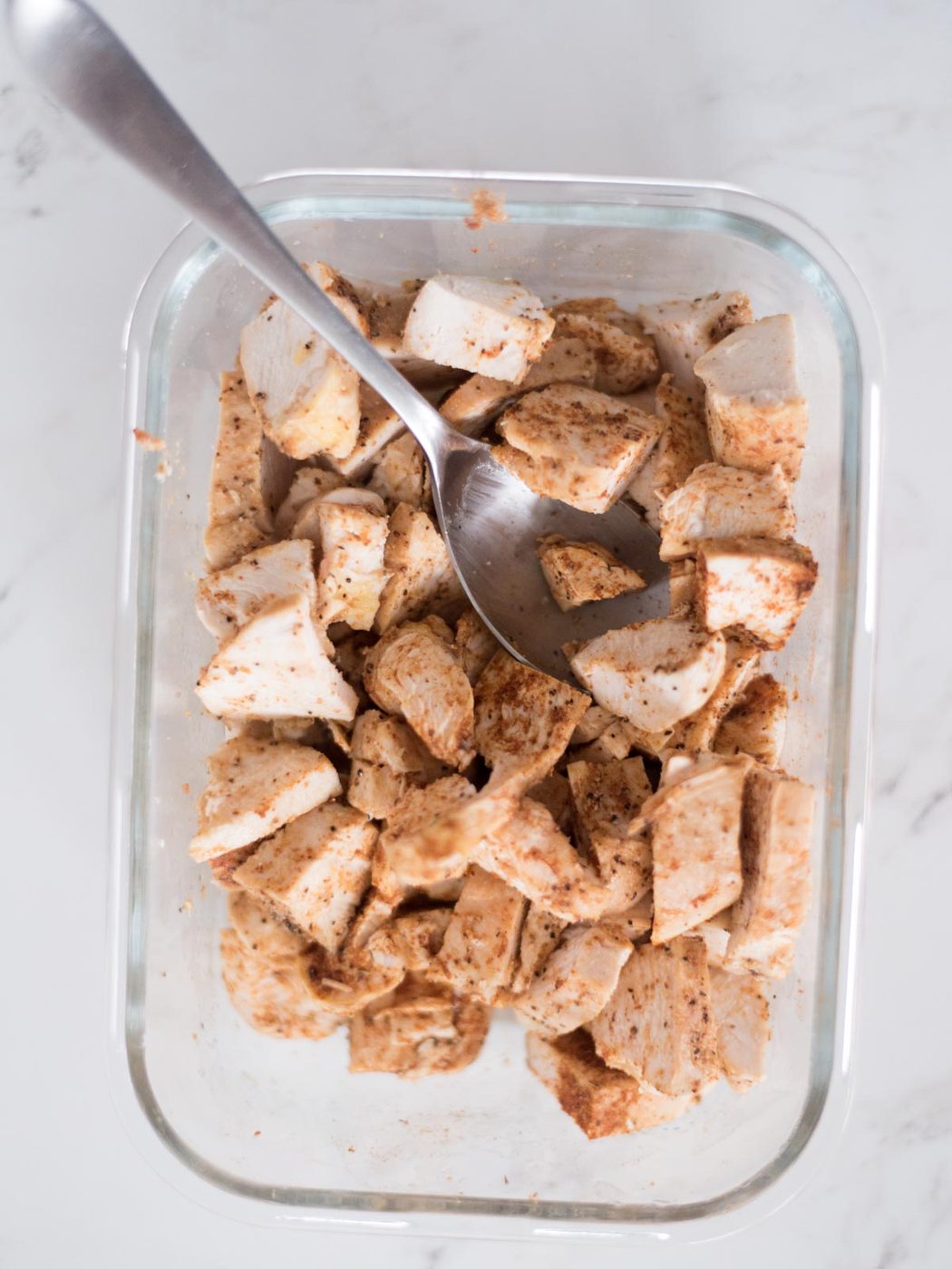Diced chicken coated with taco seasoning combined.