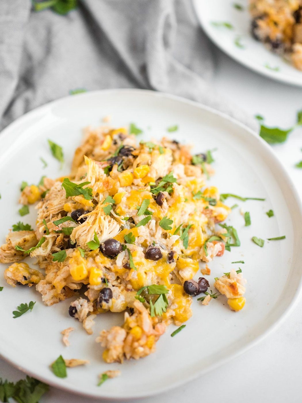 Up close shot of Tex-Mex chicken casserole on a white plate.