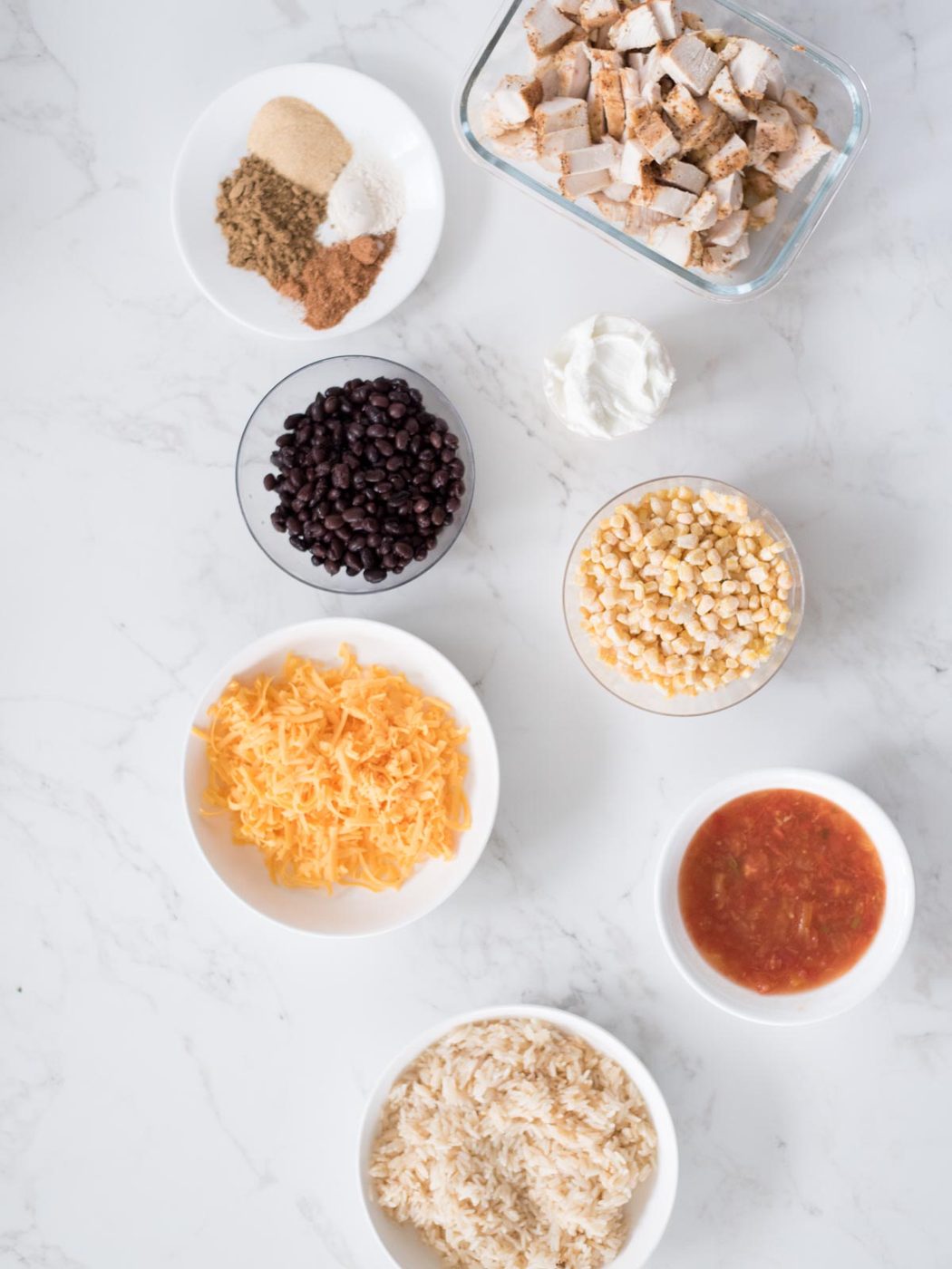 INgredients shown that are used to make Tex-Mex chicken with black beans.