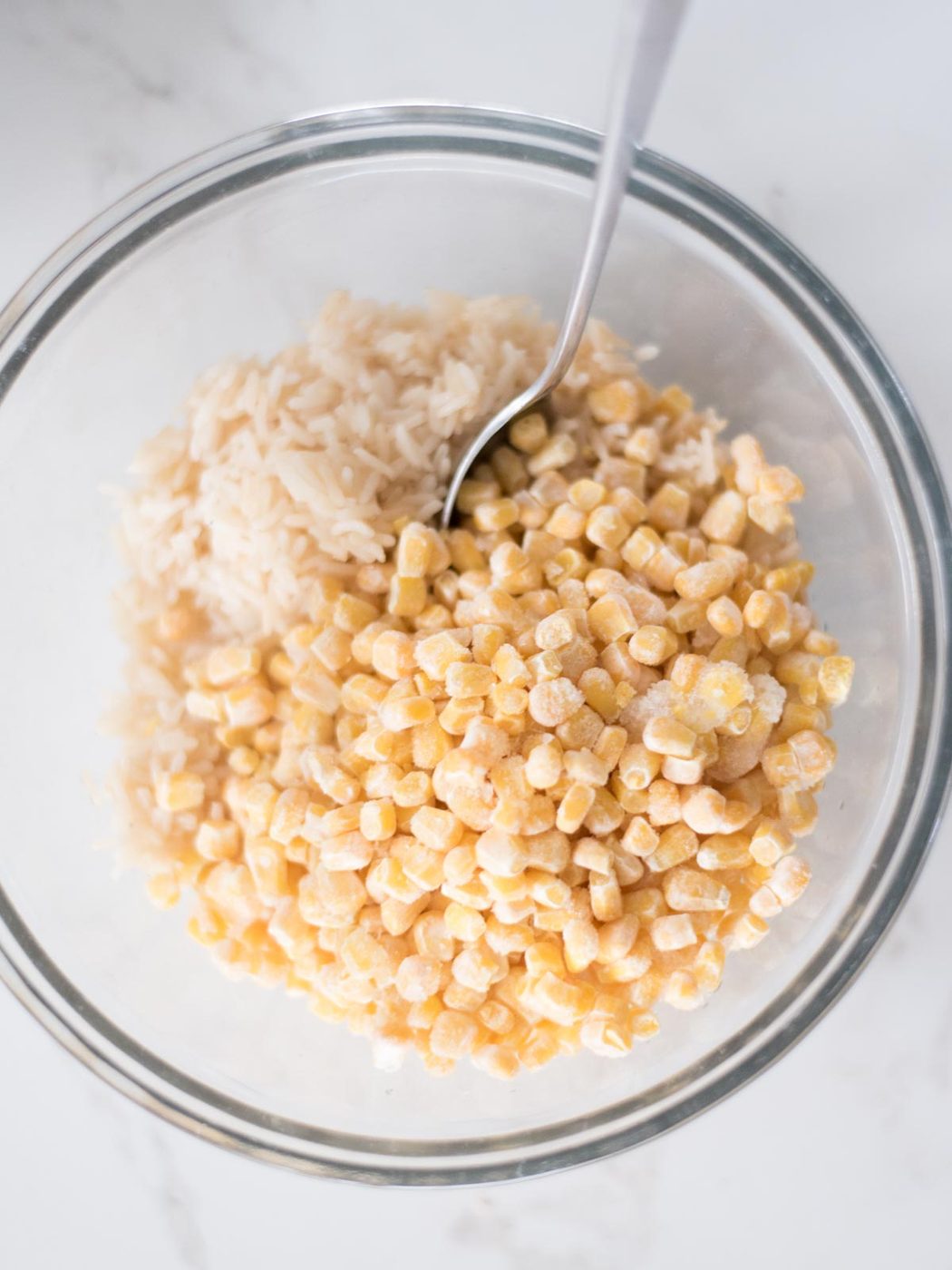Mixing bowl with corn and rice in it.