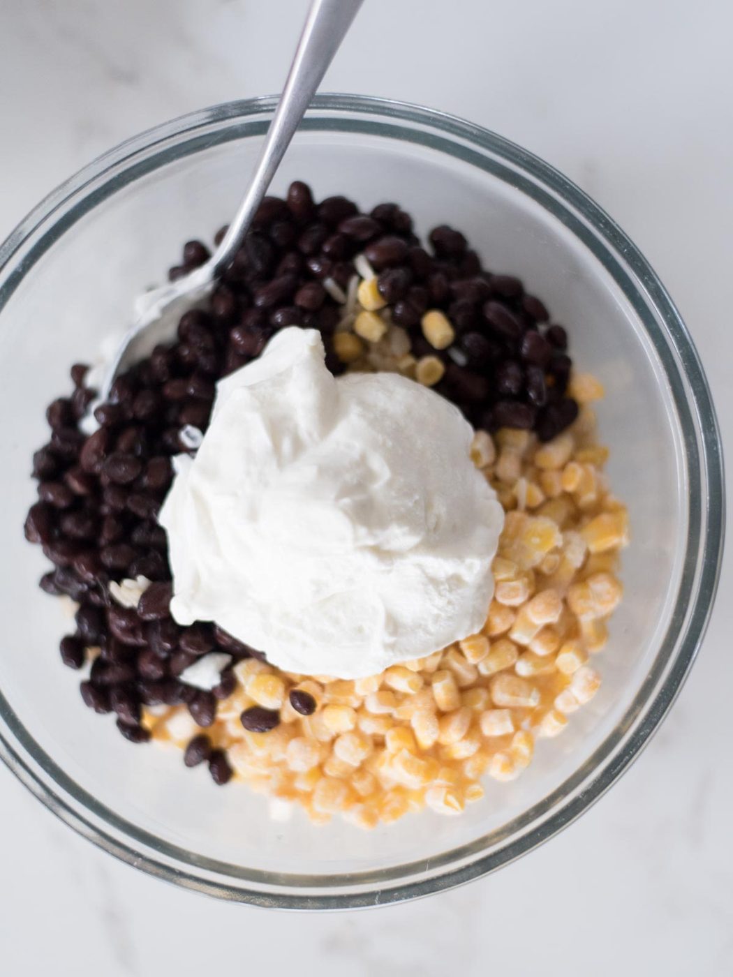 Sour cream added over the black beans.