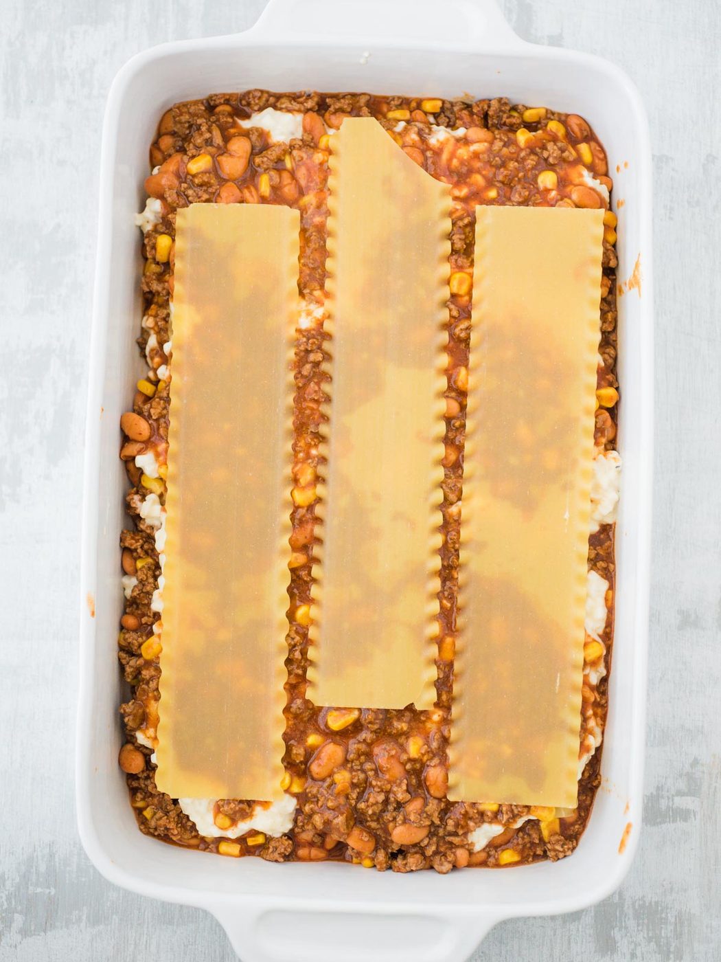 pasta noodle layer of tex mex lasagna in casserole dish