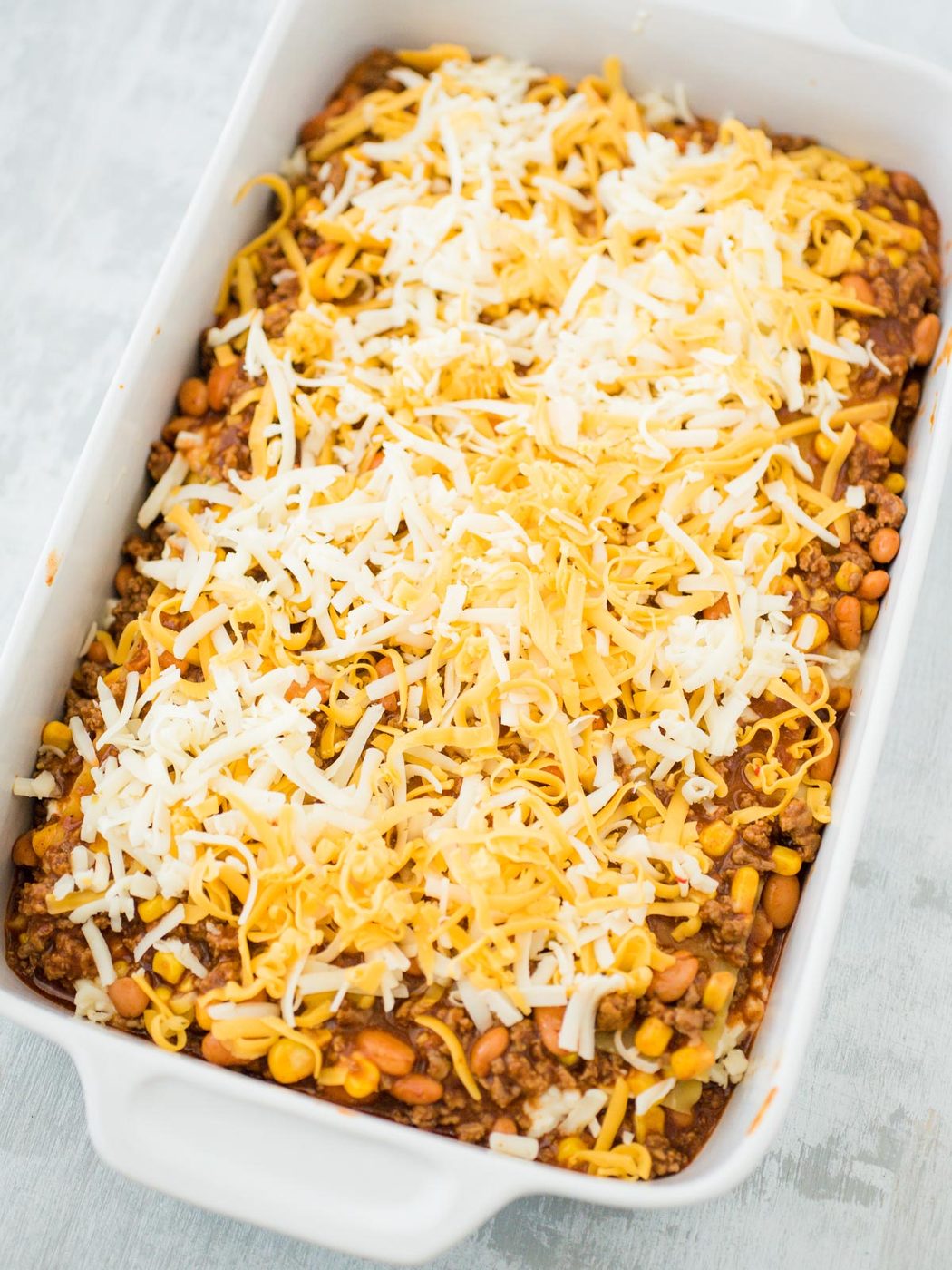 unbaked tex mex lasagna in a casserole dish