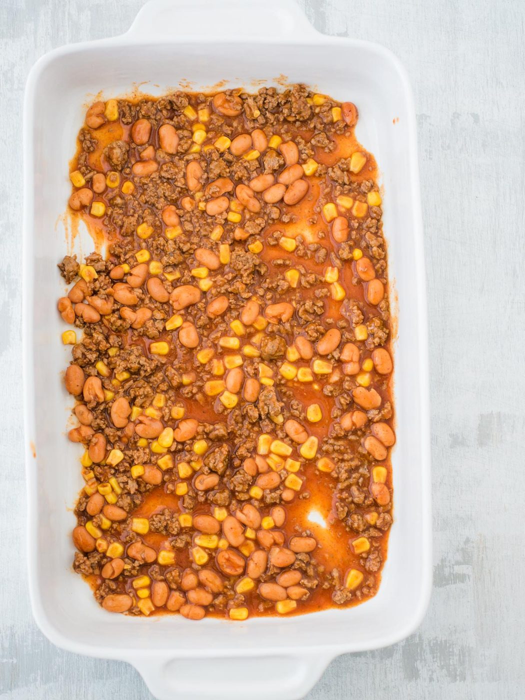 sauce in bottom of casserole dish for tex mex lasagna