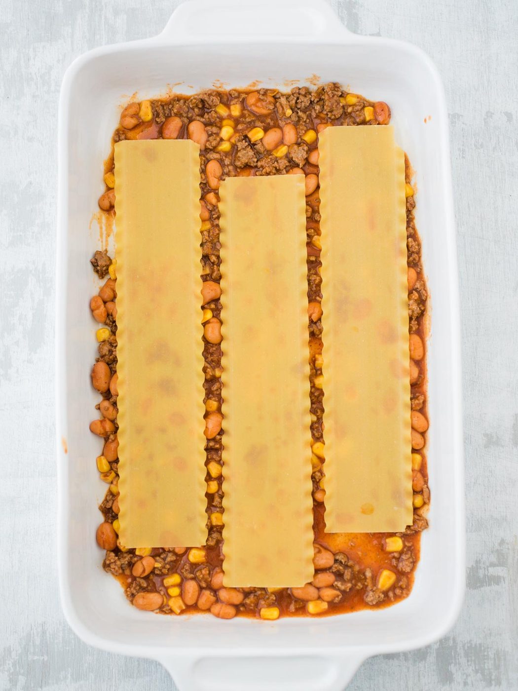 pasta noodle layer of tex mex lasagna in casserole dish