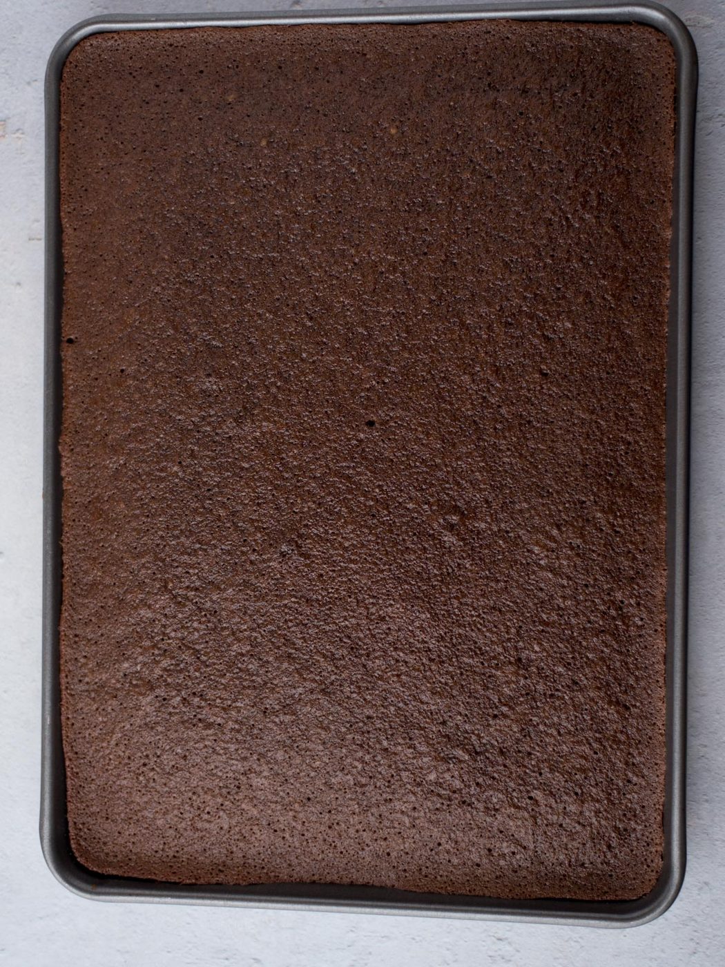 baked texas sheet cake in a baking sheet without frosting