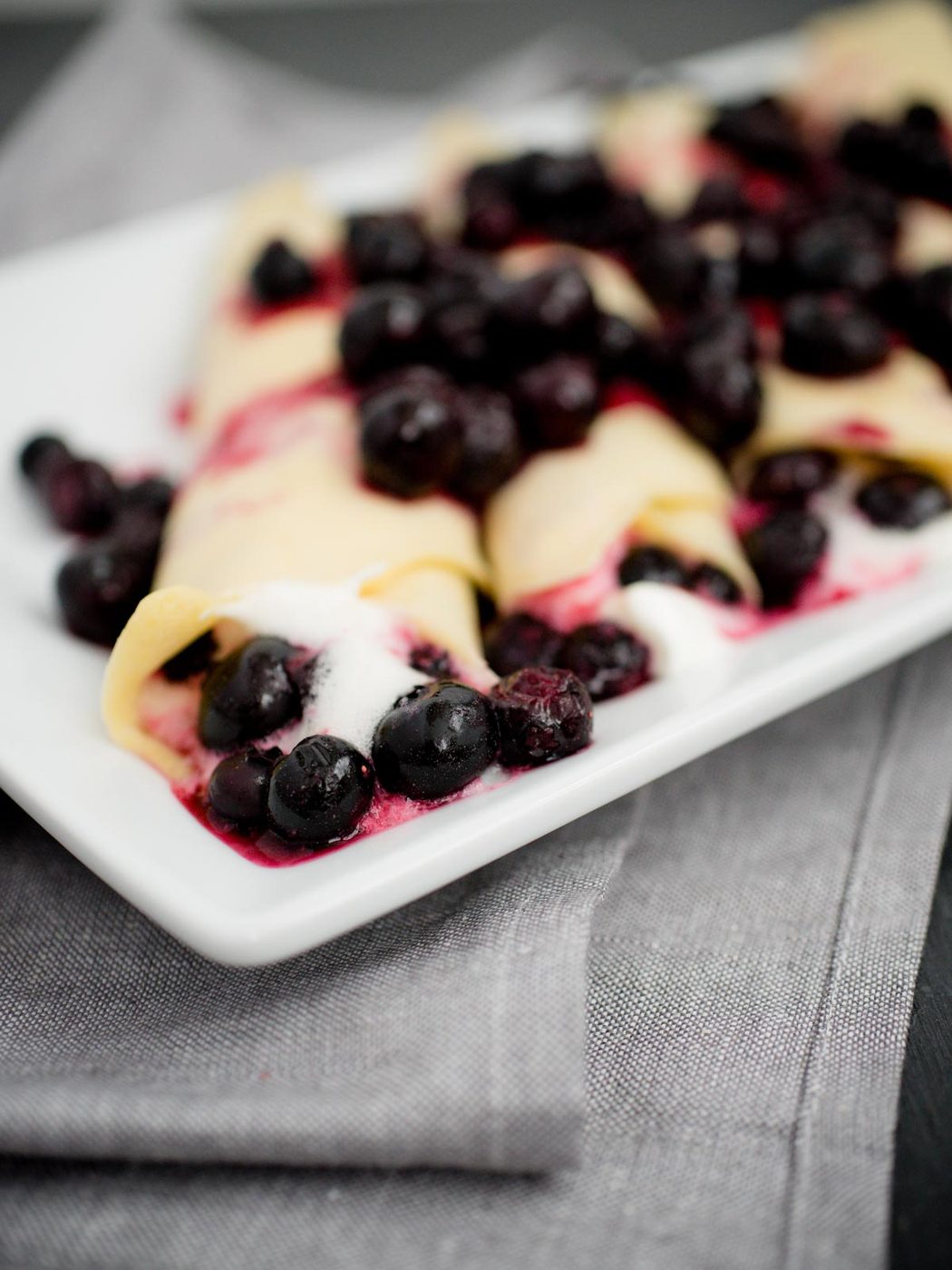 crepes filled with blueberries and whipped cream
