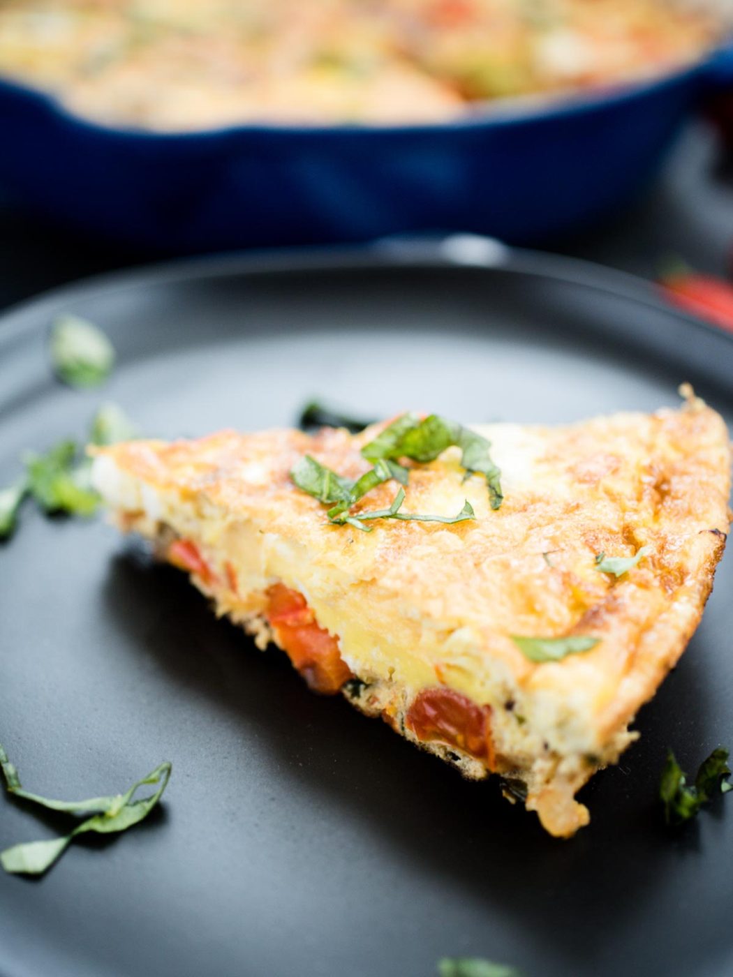 slice of frittata on a black plate