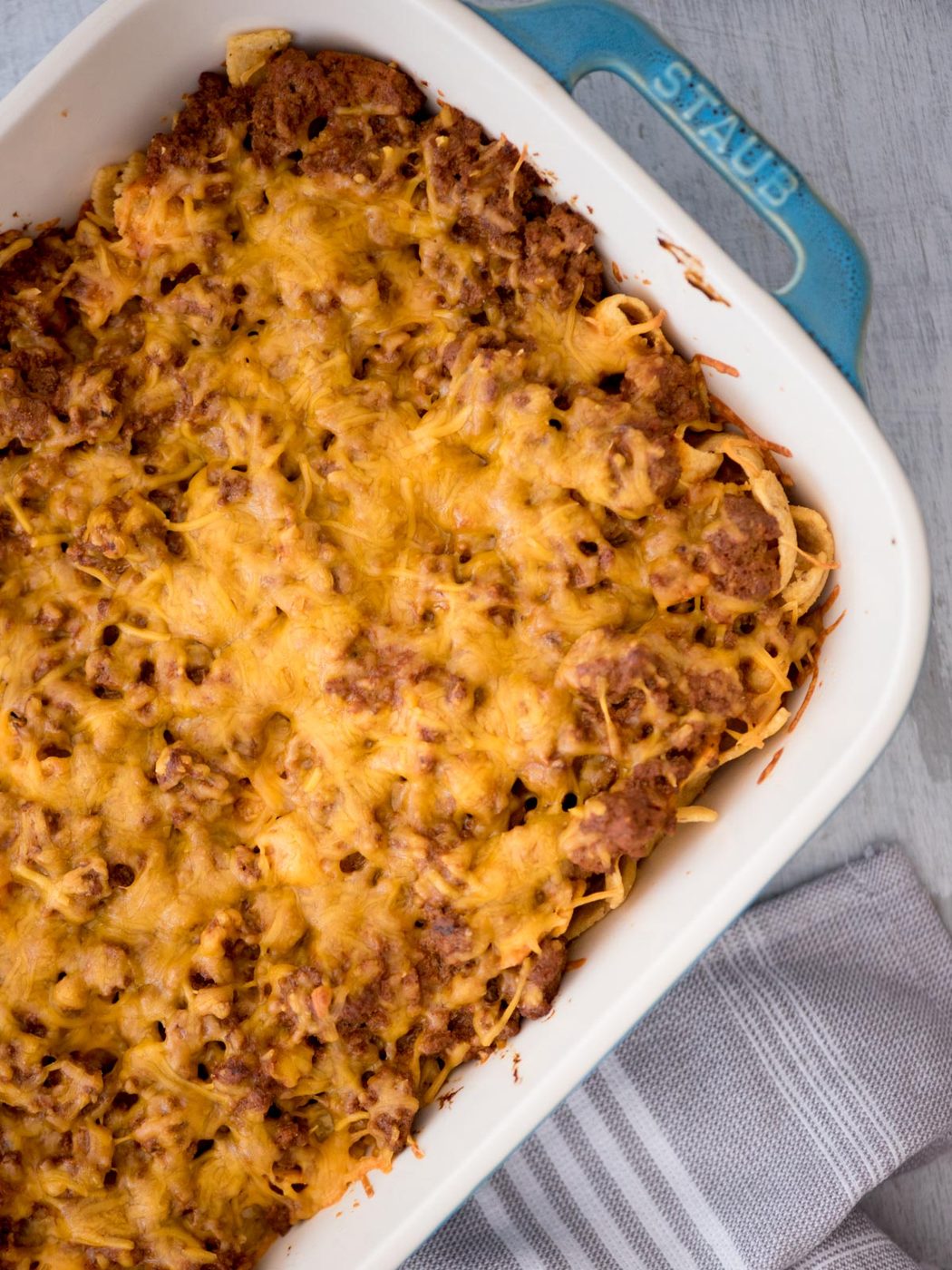 Top view of a walking taco casserole in a baking dish.