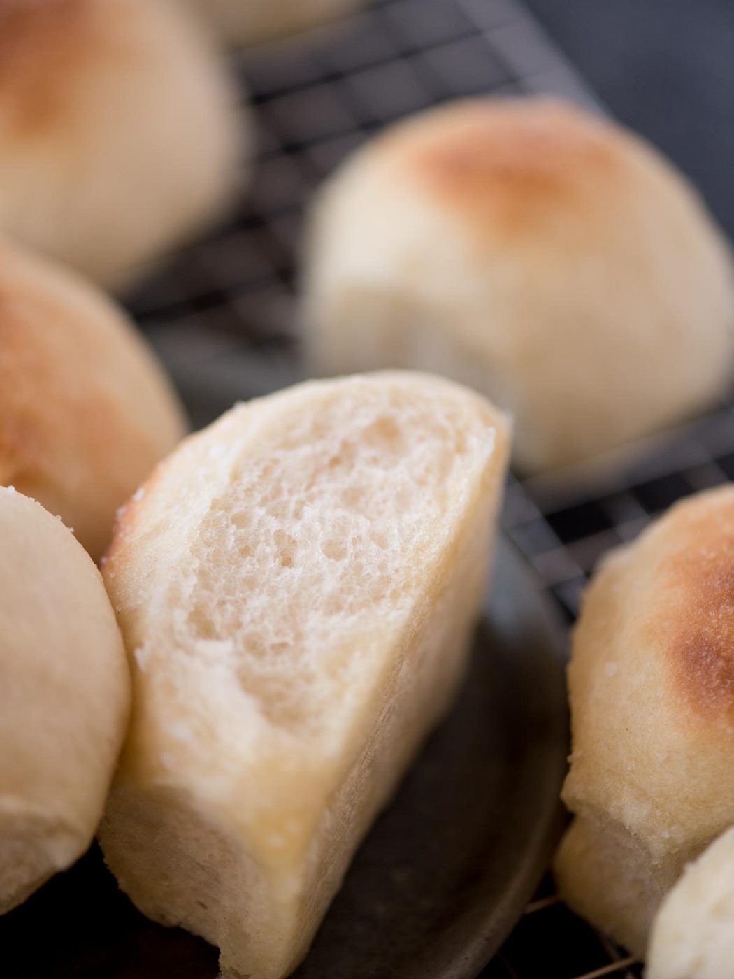 a light and fluffy from-scratch yeast roll laying on its side on a plate