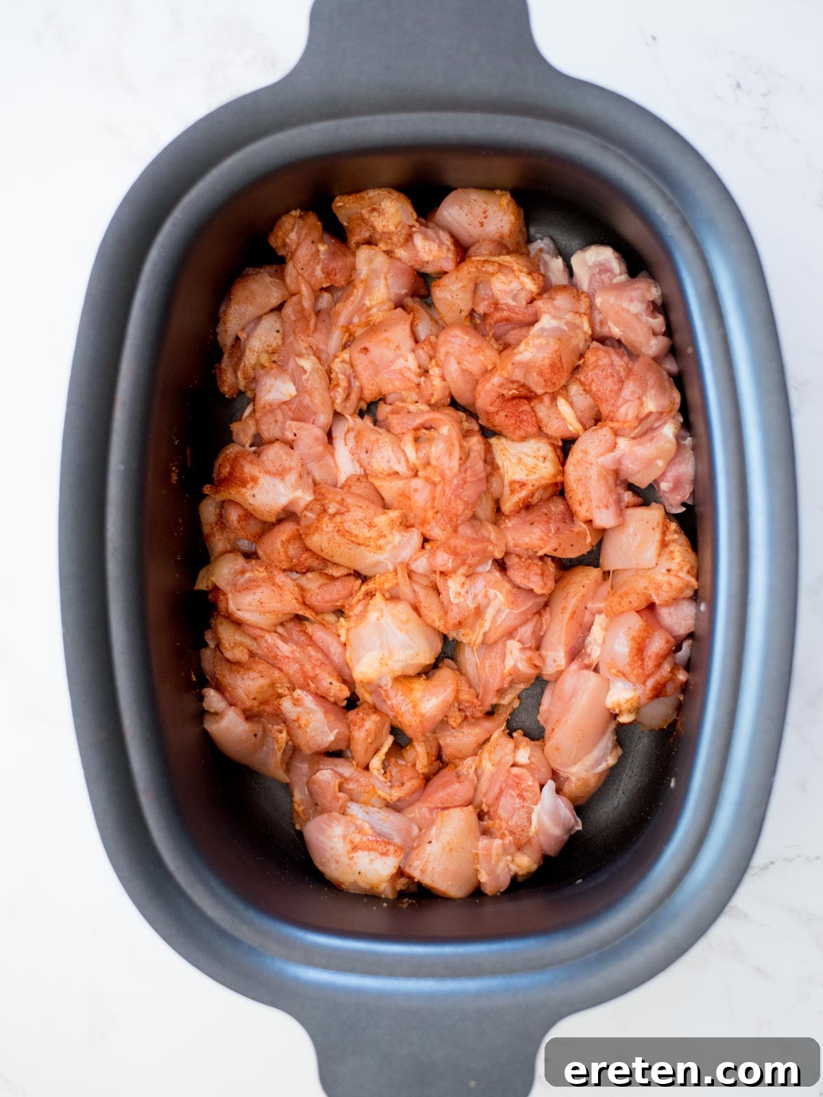 chicken and seasoning in a crockpot for chicken chili