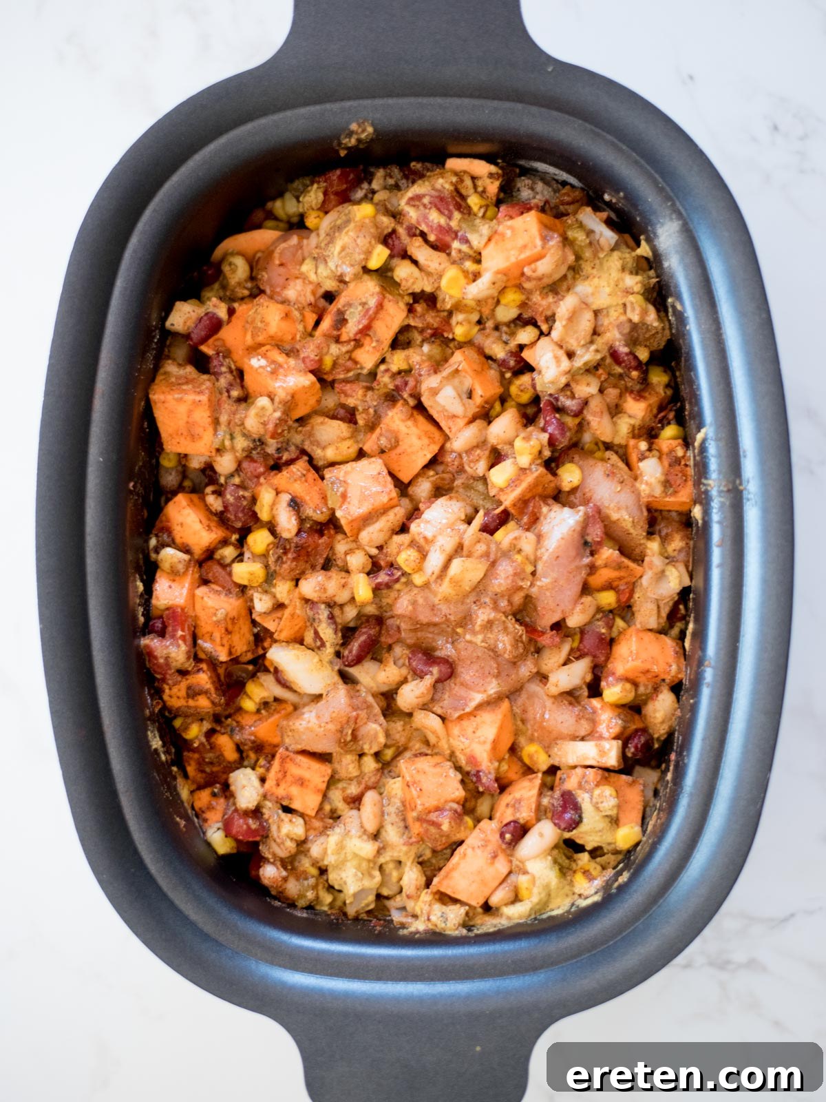 ingredients for chicken chili uncooked in the crock pot