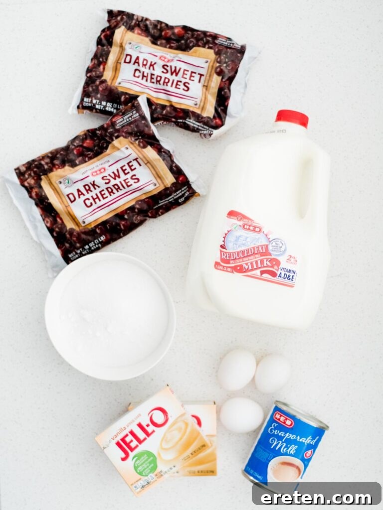A selection of ingredients laid out on a surface, ready to make homemade dark cherry ice cream.
