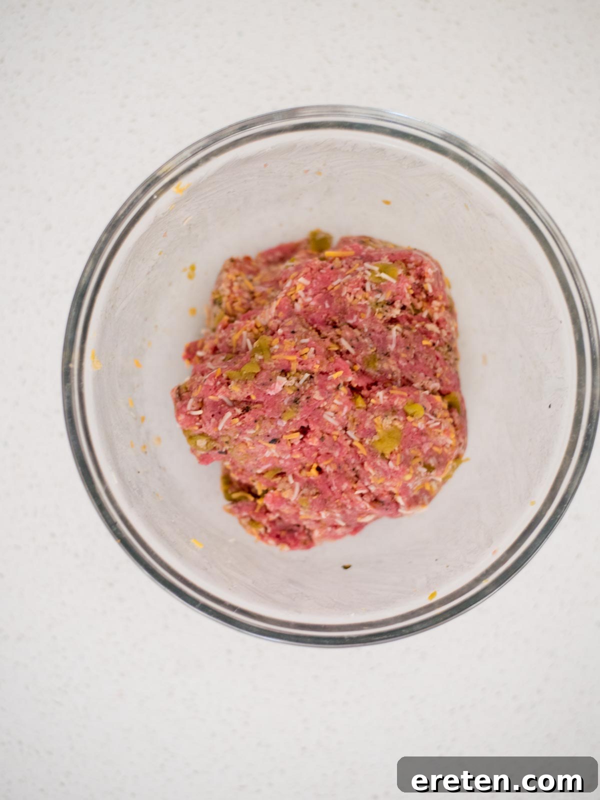 ingredients for smoked burgers mixed together in a bowl