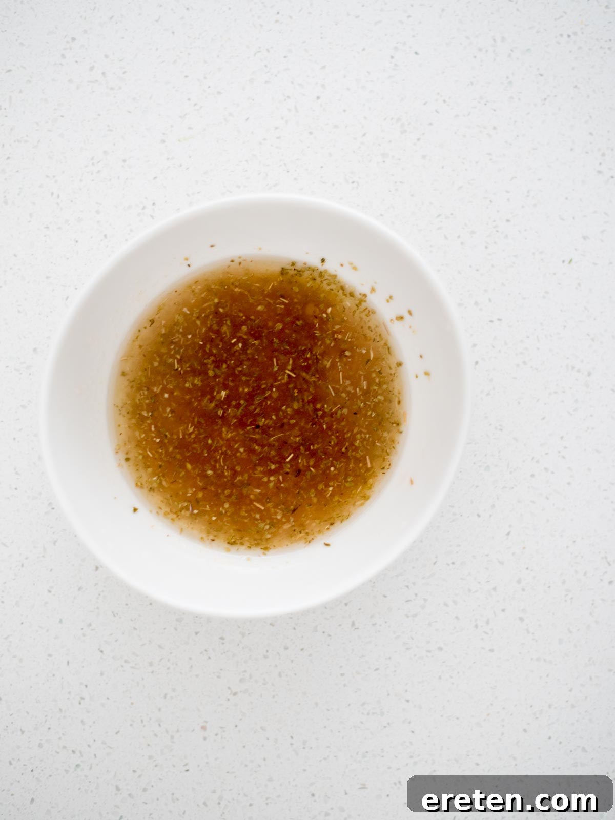 greek dressing mixed together in a small mixing bowl