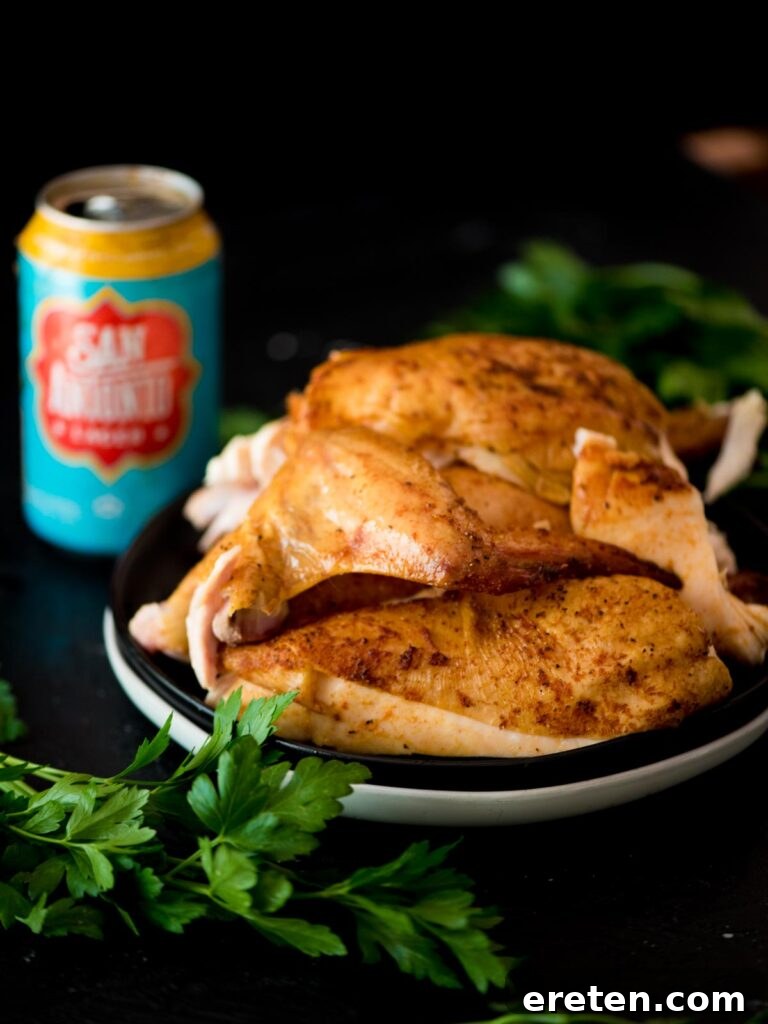 Pint-Infused Smoked Chicken Feast 2 pit boss beer can chicken on a plate with a beer