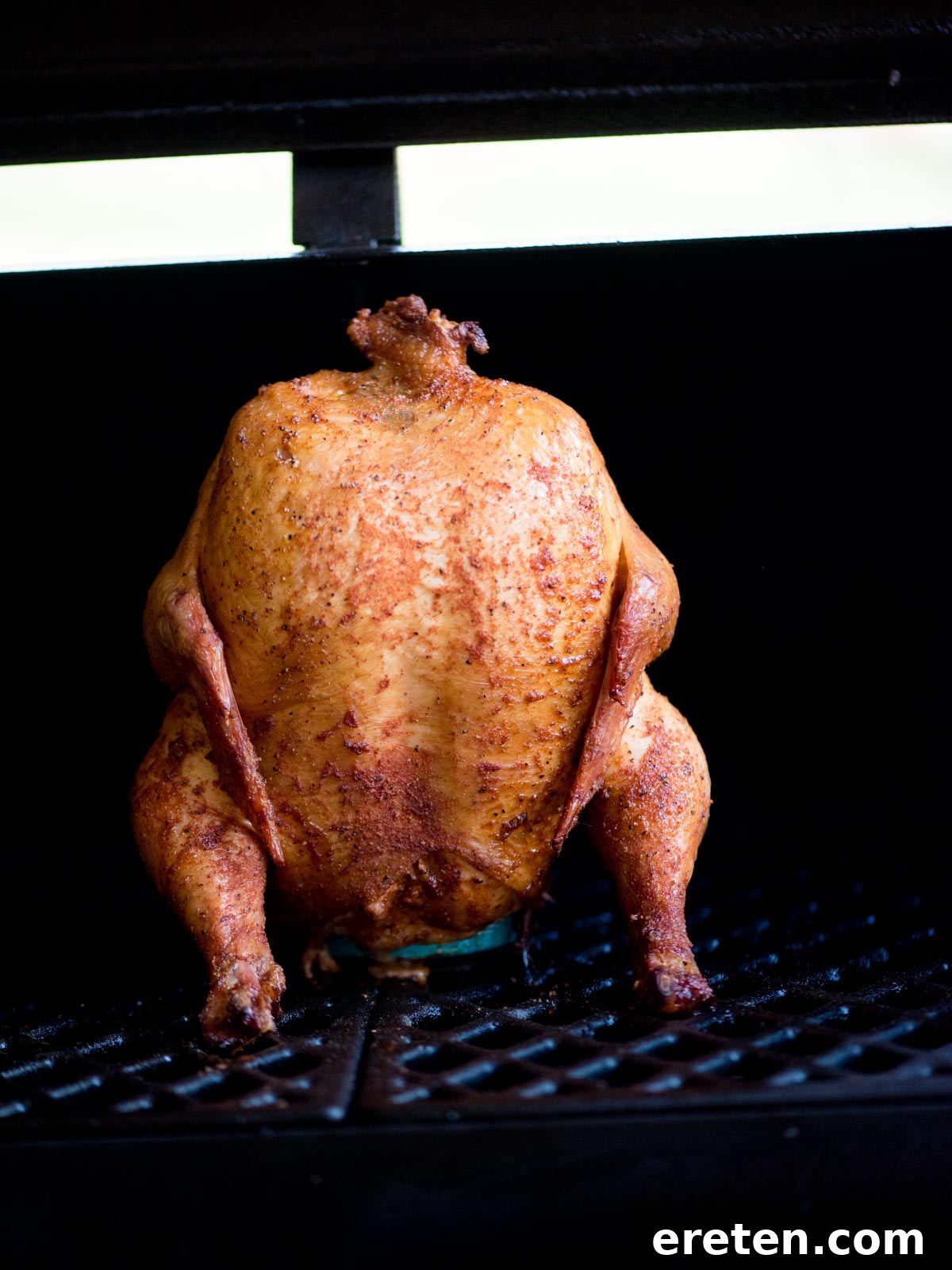 Pint-Infused Smoked Chicken Feast 6 fully cooked beer can smoked chicken sitting on a pit boss grill