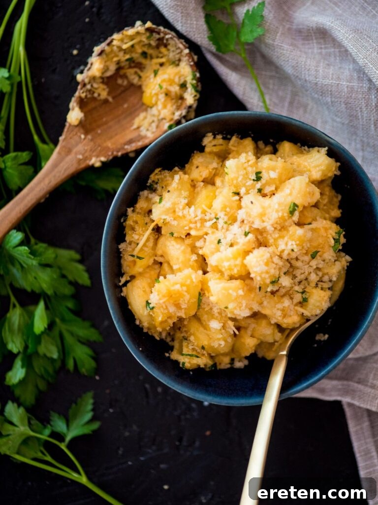 Next-Level Smoked Macaroni 2 smoked mac n cheese in a blue bowl with a fork surrounded by parsley