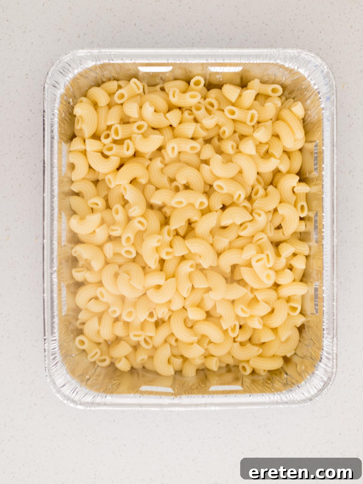Next-Level Smoked Macaroni 11 cooked elbow pasta added to a disposable cake pan
