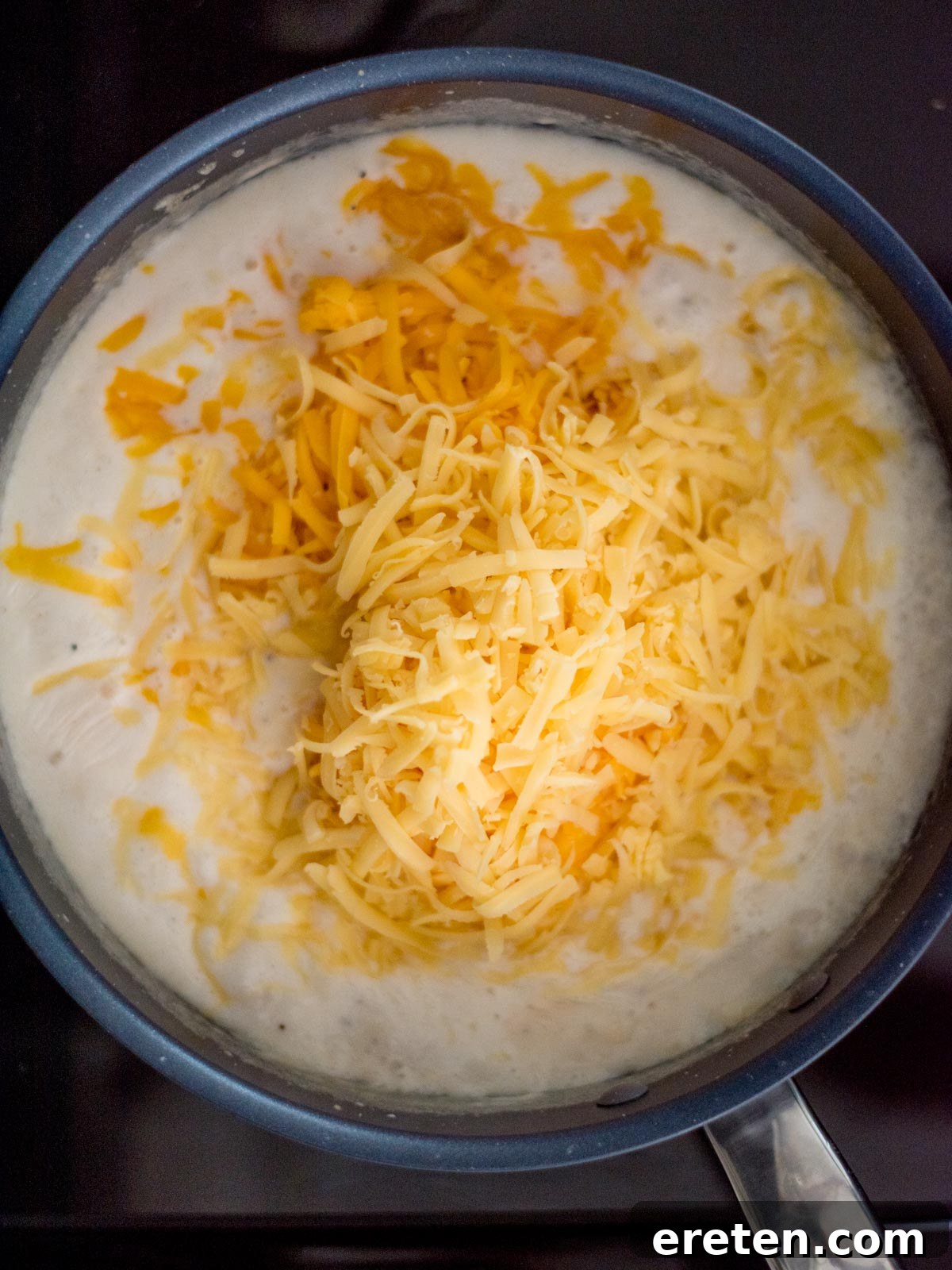 Next-Level Smoked Macaroni 9 cheeses added to the skillet with the roux and half and half