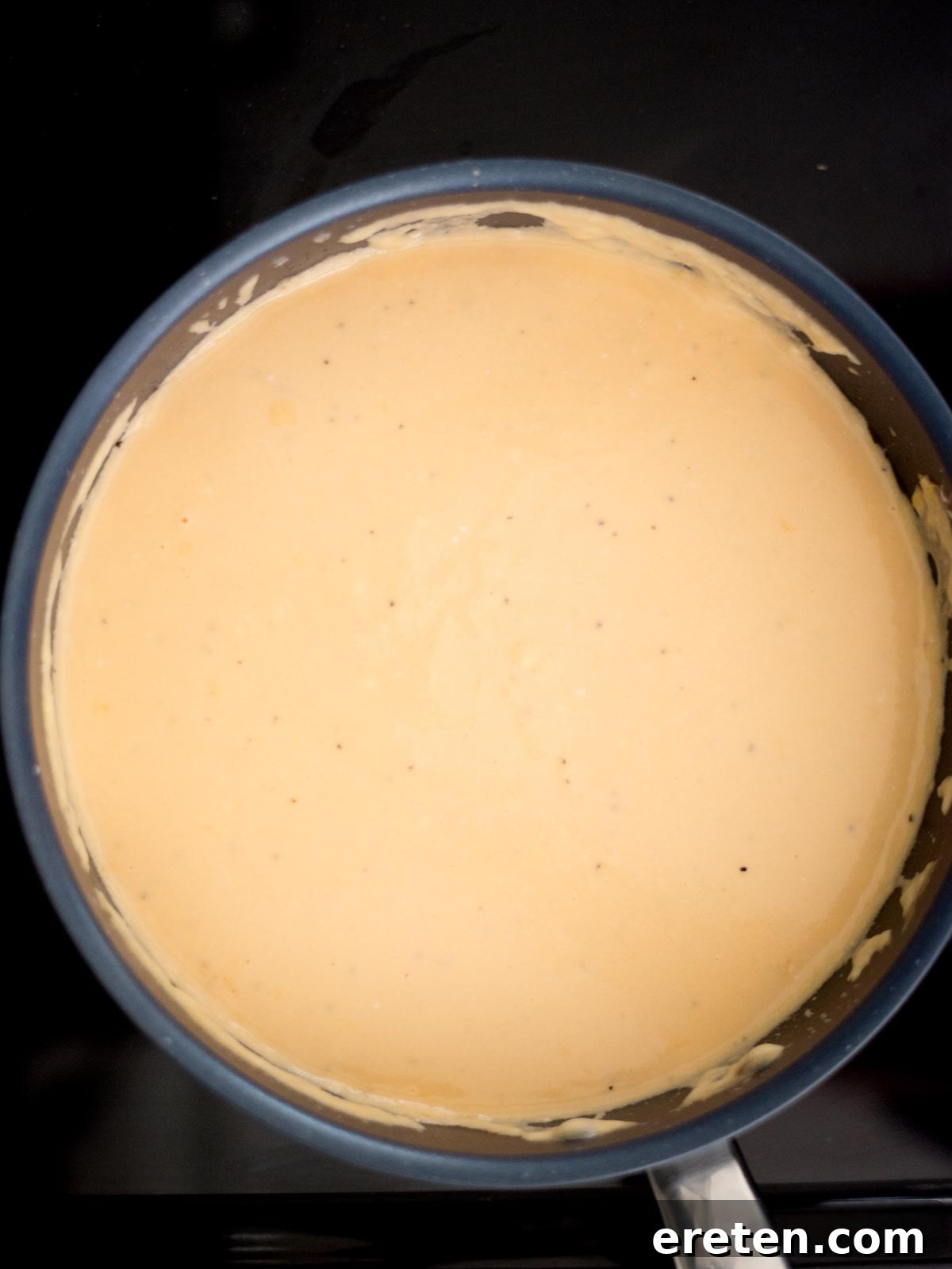 Next-Level Smoked Macaroni 10 cheese sauce cooking in the skillet