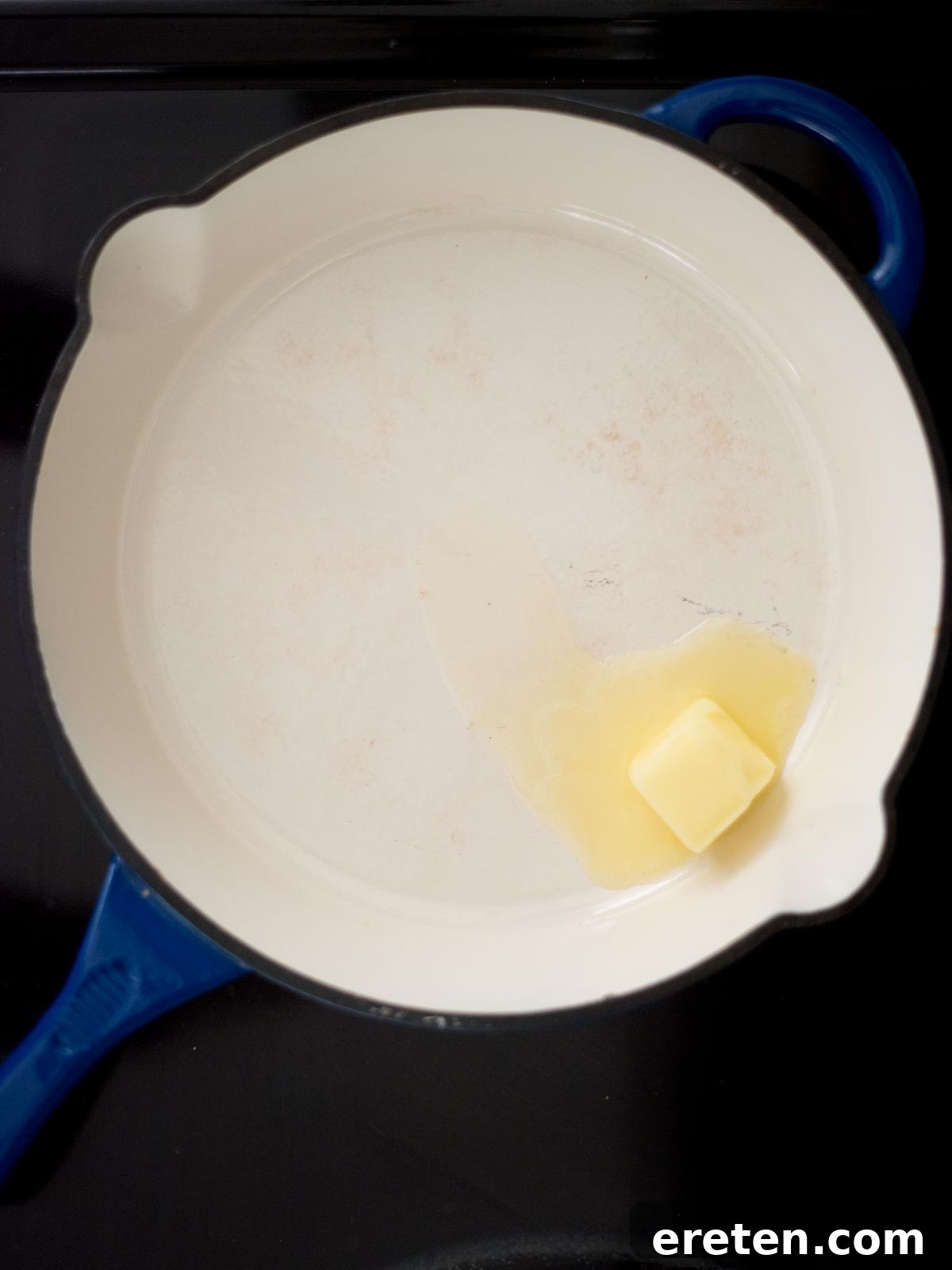 Hearty Southern Brown Gravy 4 Close-up shot of butter melting in a skillet on a stovetop, forming a golden pool.