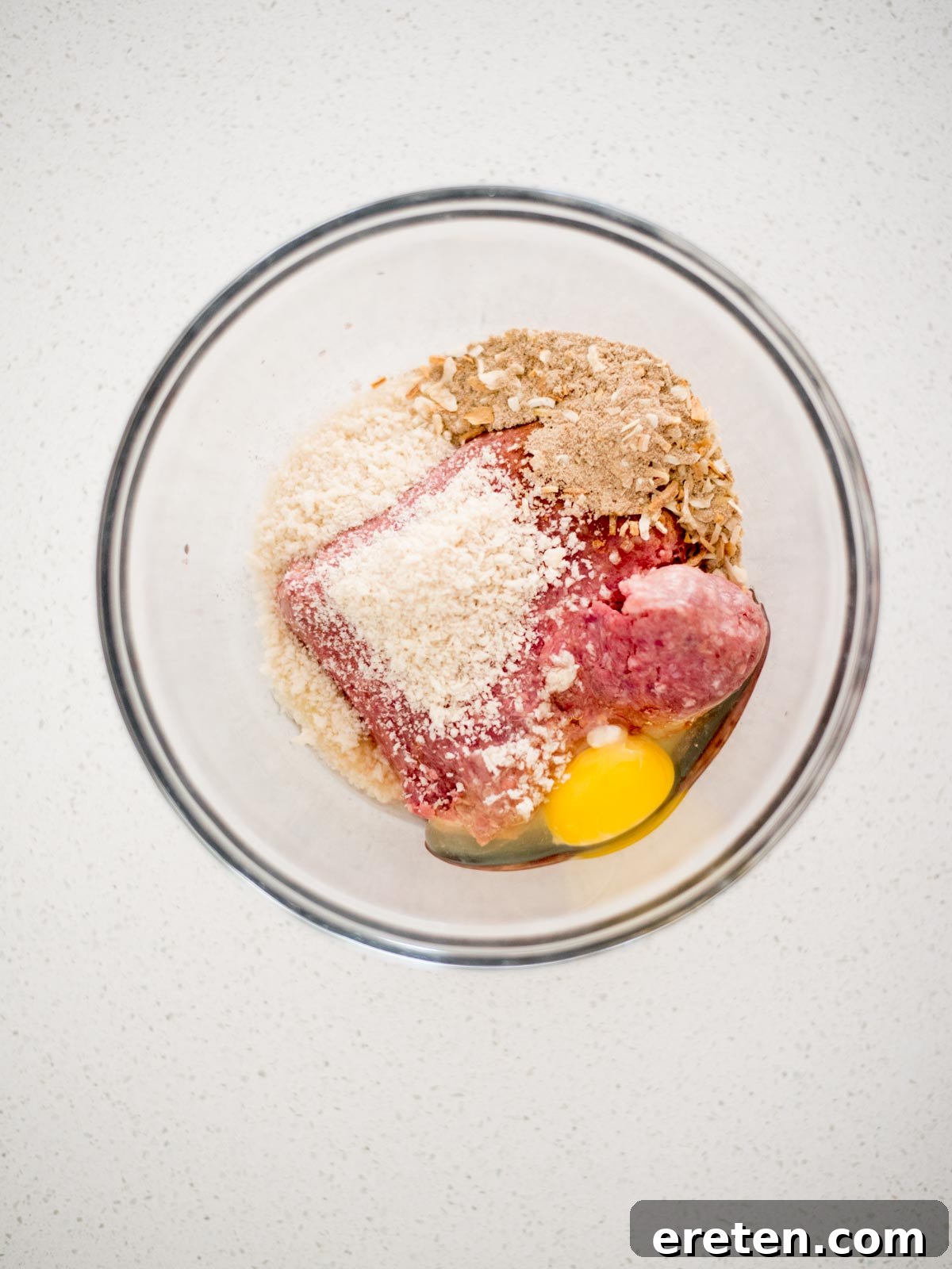 all meatball ingredients - ground beef, egg, onion soup mix, and panko breadcrumbs - added to a large mixing bowl