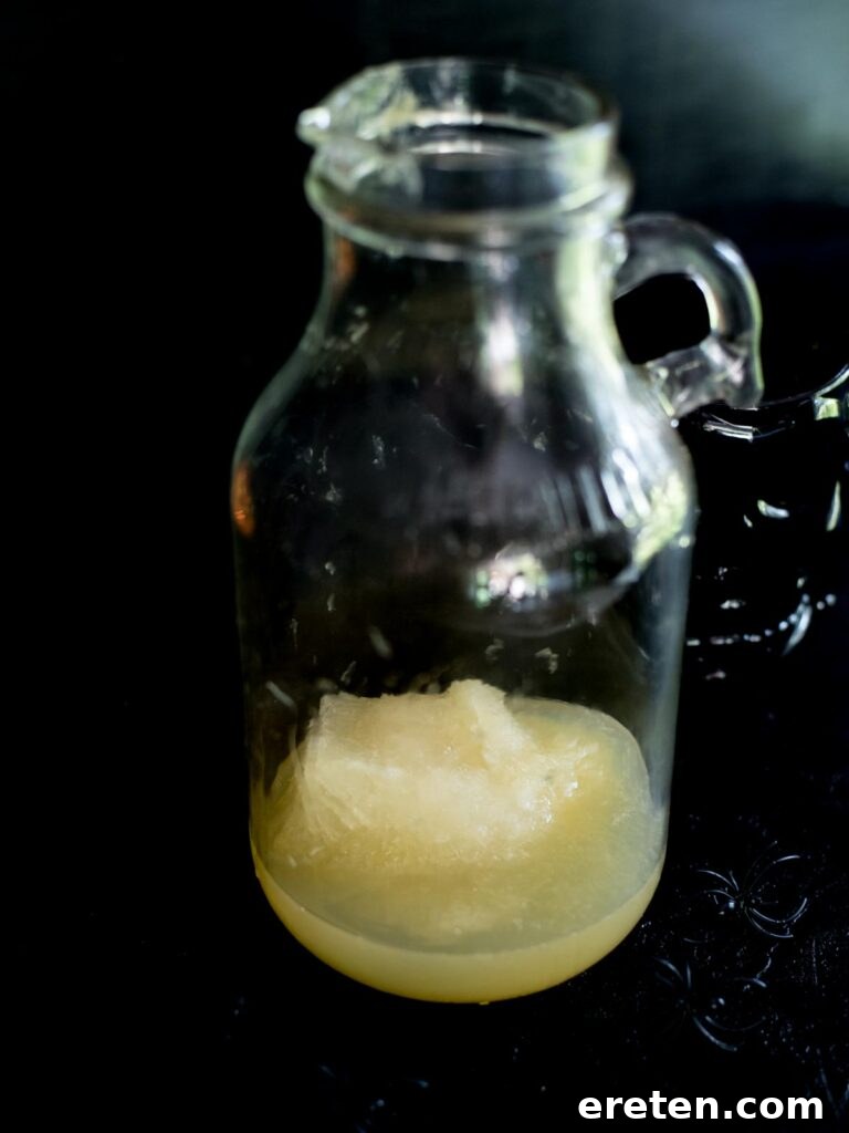 Frozen limeade concentrate poured into a pitcher, ready for the next step of making Bug Juice.