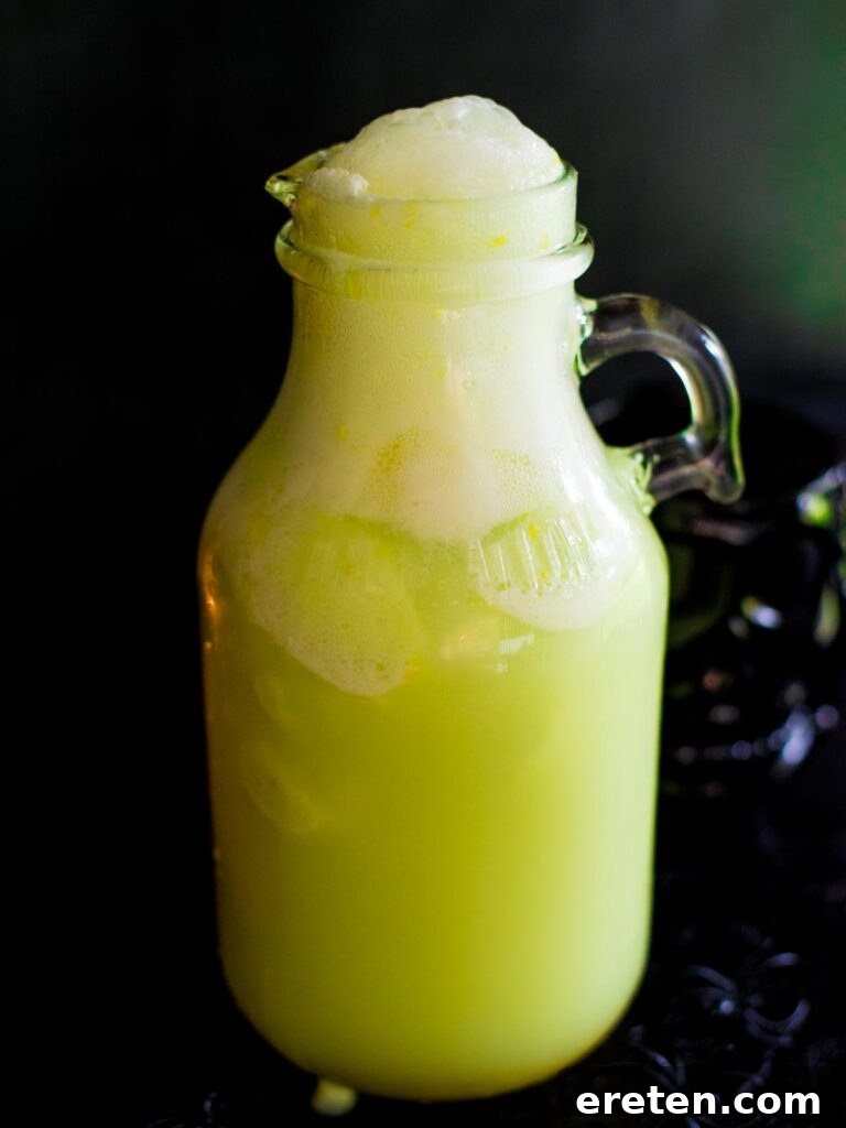 The completed Bug Juice drink in a pitcher, featuring combined Sprite, frozen limeade, and melted lime sherbet, ready for serving.