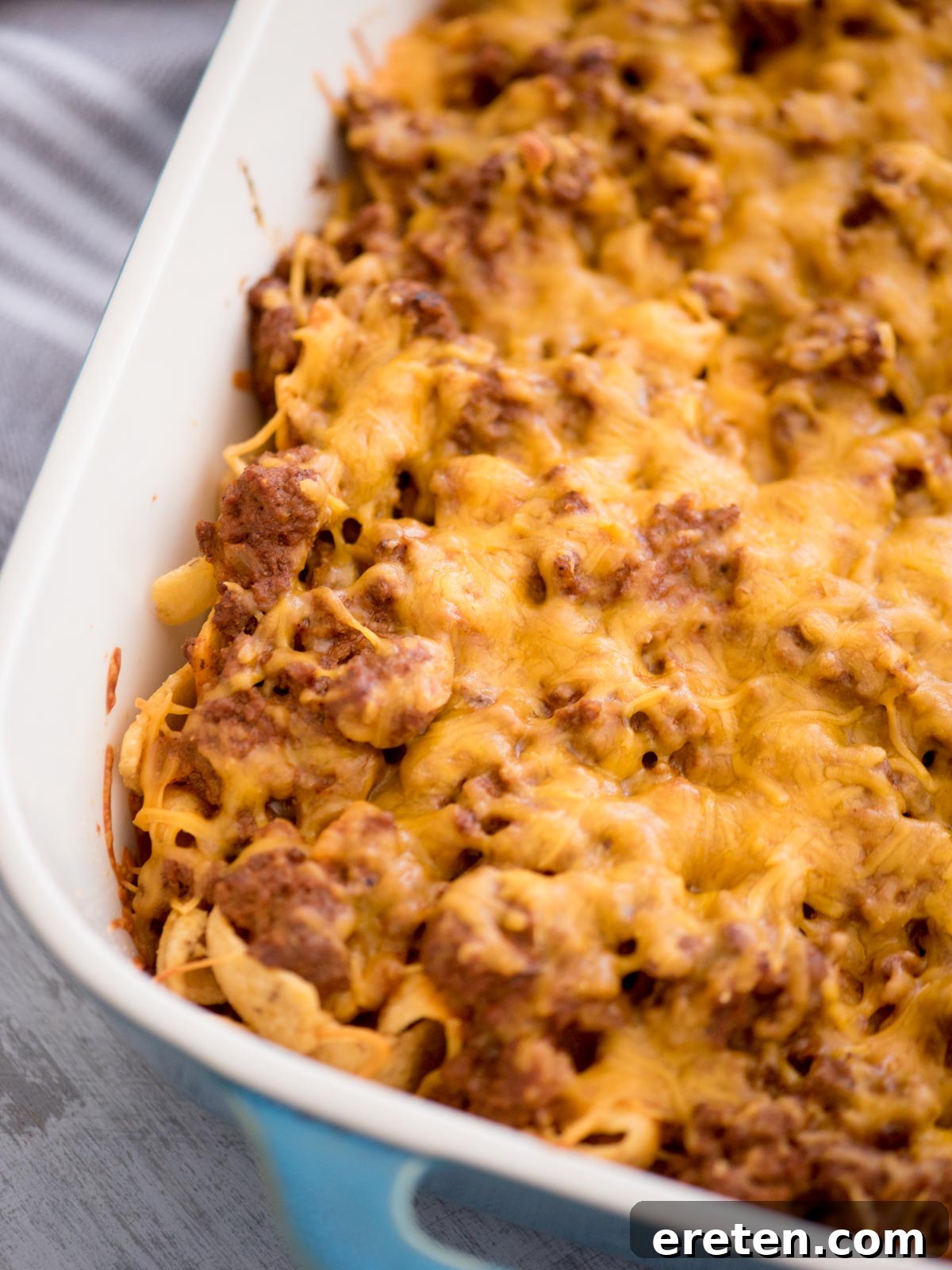 The Walking Taco Casserole presented in a full baking dish, showcasing its cheesy top and hearty layers, inviting you to dig in.