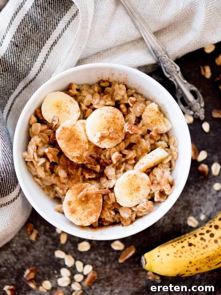 Cozy Banana Bread Oatmeal 2 banana oatmeal in a bowl topped with nuts and cinnamon