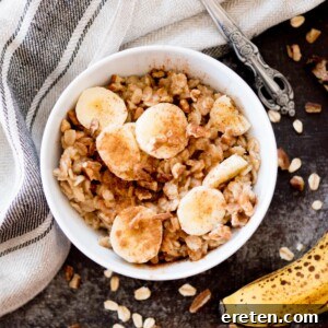 banana oatmeal in a bowl topped with cinnamon and nuts