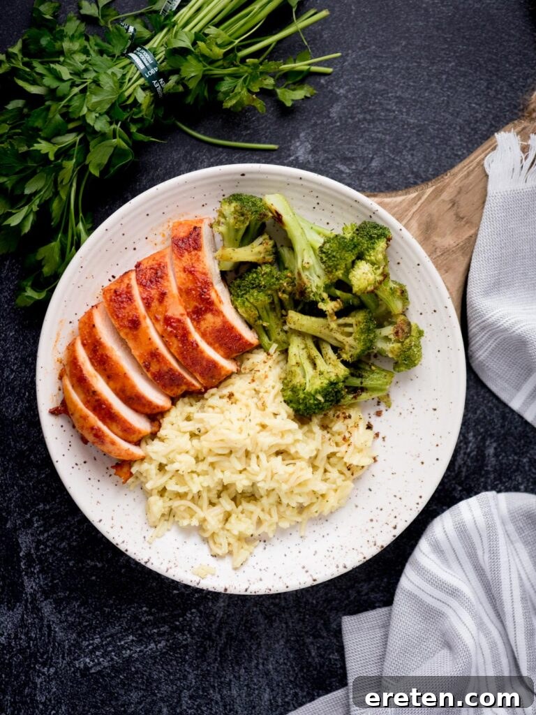 Flavorful Smoked Chicken Breast from Your Pellet Grill 7 Sliced smoked chicken breast plated with broccoli and rice, showcasing a perfectly cooked interior.
