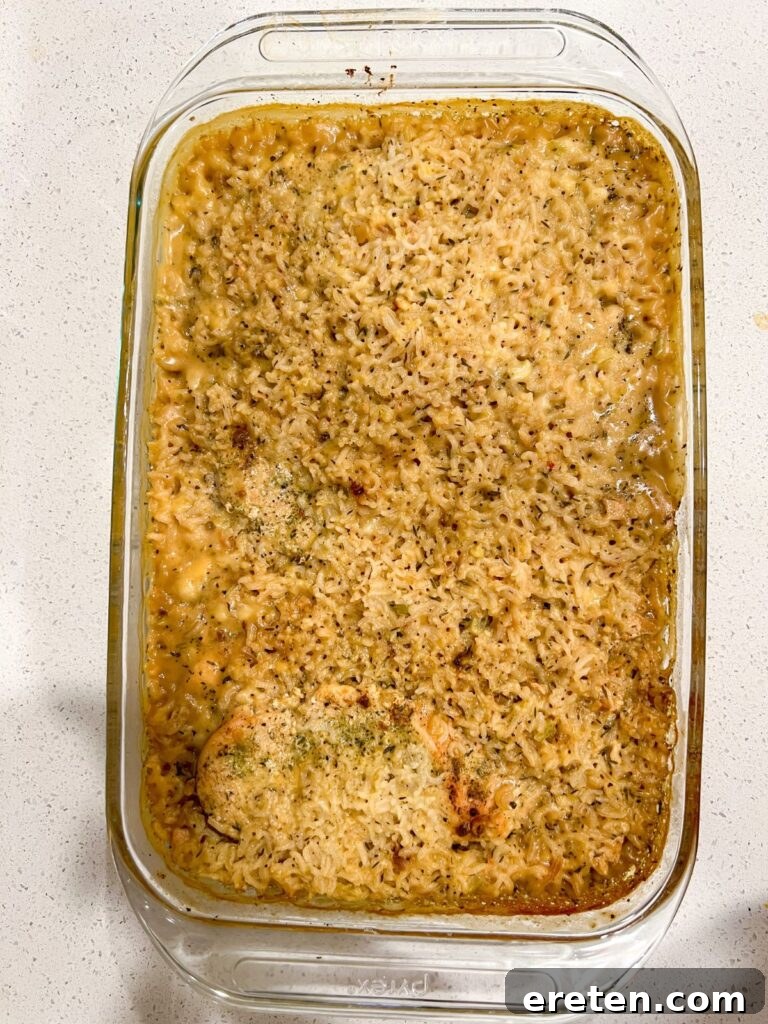 Serving of No-Peek Chicken Casserole in a pyrex dish with a spoon