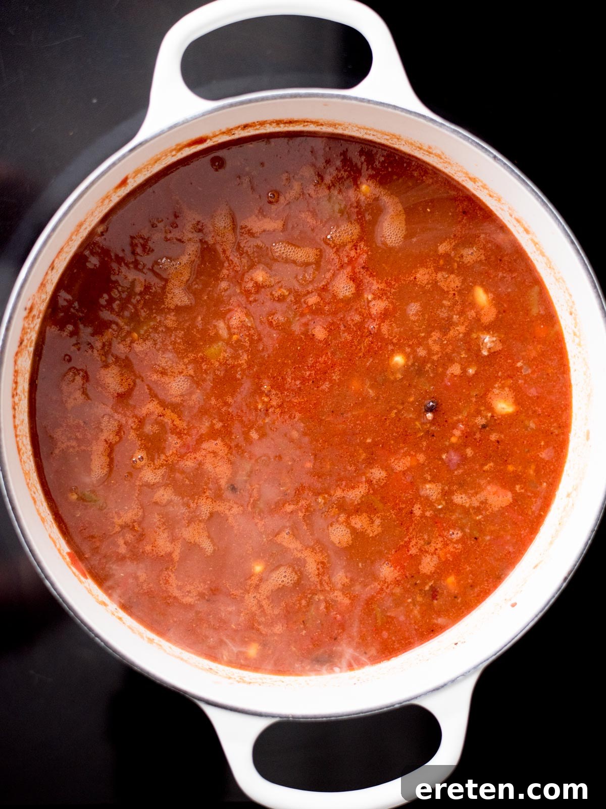 The taco soup ingredients simmering gently in a dutch oven, allowing flavors to meld.